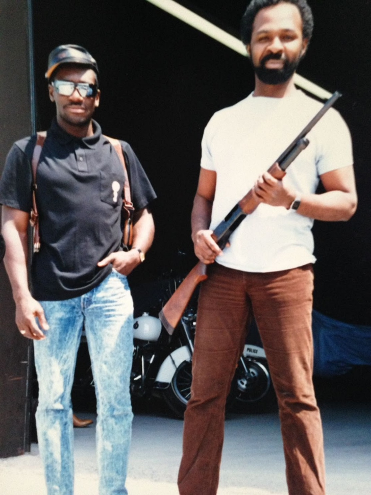 A younger Keith Merith standing with a friend during an early off-duty moment