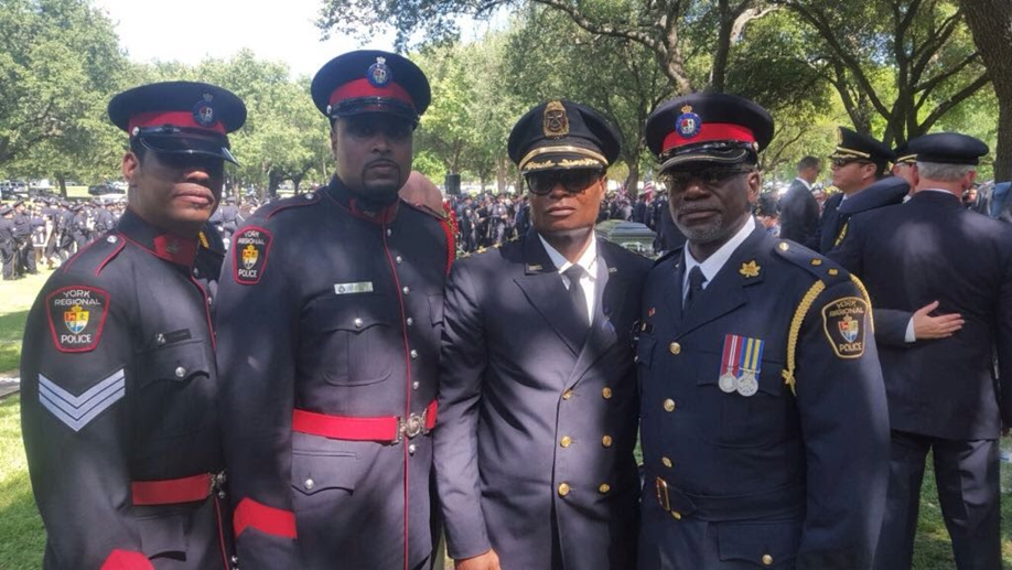 Keith Merith with fellow officers in ceremonial uniform at an outdoor police gathering